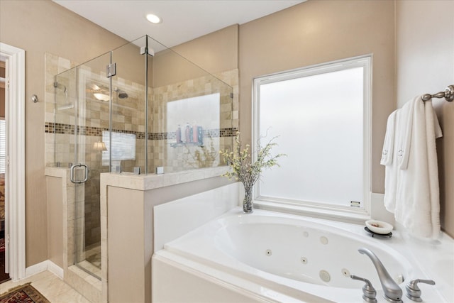 bathroom featuring a stall shower, a tub with jets, and recessed lighting