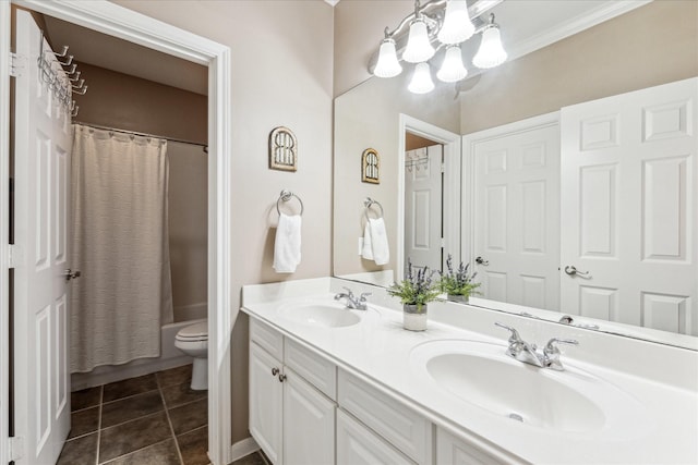 bathroom with toilet, double vanity, a sink, and tile patterned floors