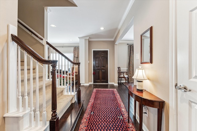 entryway featuring recessed lighting, ornamental molding, wood finished floors, baseboards, and stairs