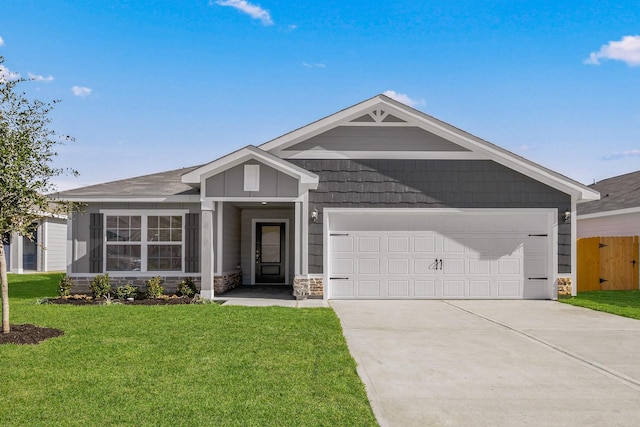 view of front of home featuring concrete driveway, an attached garage, fence, stone siding, and a front lawn