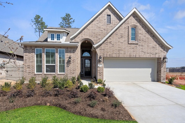 view of front of home with a garage, concrete driveway, and brick siding