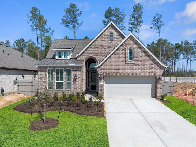 view of front of house featuring concrete driveway, a standing seam roof, fence, a front lawn, and brick siding