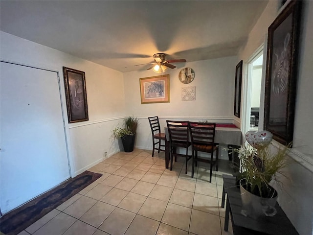 dining space with ceiling fan and light tile patterned floors