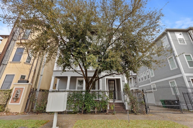 multi unit property with a fenced front yard and a gate