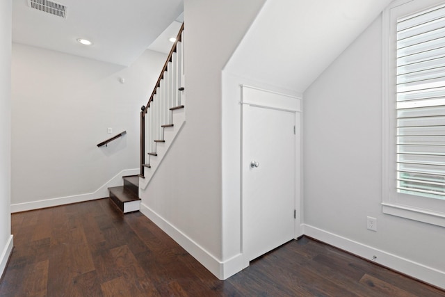 stairs featuring visible vents, baseboards, and wood finished floors