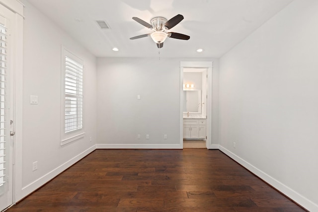 empty room featuring recessed lighting, dark wood-style flooring, visible vents, and baseboards