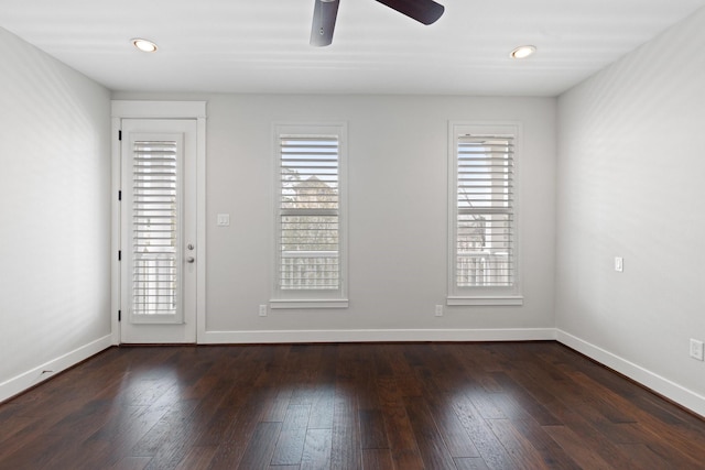 spare room with dark wood-style floors, baseboards, and recessed lighting