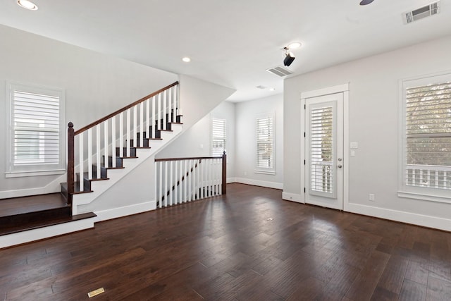 entrance foyer with visible vents, baseboards, and wood finished floors