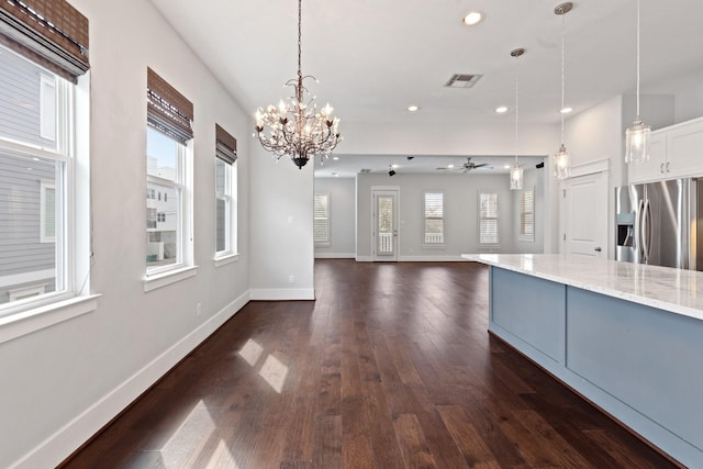 kitchen with baseboards, dark wood finished floors, decorative light fixtures, and stainless steel fridge with ice dispenser