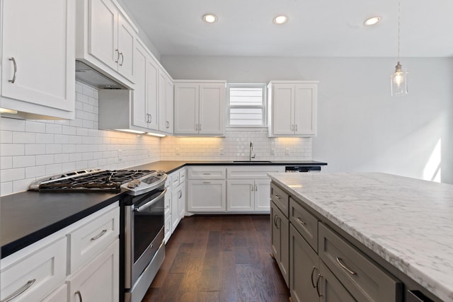 kitchen with stainless steel gas range, dark wood finished floors, a sink, and recessed lighting