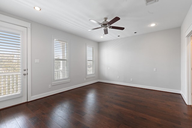 spare room featuring ceiling fan, recessed lighting, dark wood-type flooring, visible vents, and baseboards