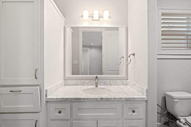 bathroom with toilet and vanity