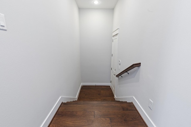 stairs featuring baseboards and wood finished floors