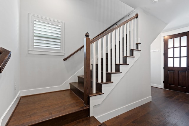 stairs featuring hardwood / wood-style flooring and baseboards