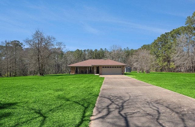 view of front of property with a view of trees, concrete driveway, a front yard, a garage, and brick siding