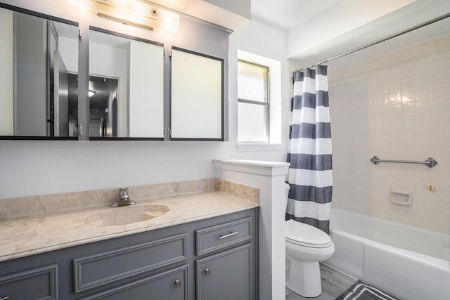 full bathroom with wood finished floors, toilet, shower / bath combo, and vanity