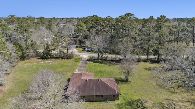 drone / aerial view with a wooded view