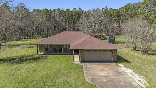 ranch-style home featuring brick siding, a front lawn, concrete driveway, covered porch, and an attached garage