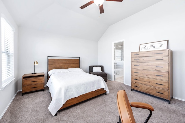 bedroom with light carpet, baseboards, a ceiling fan, connected bathroom, and lofted ceiling