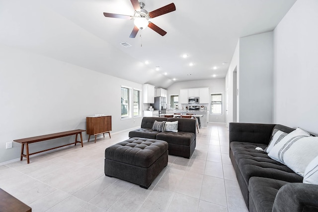 living room with lofted ceiling, plenty of natural light, recessed lighting, and light tile patterned flooring