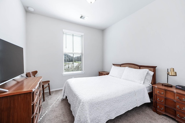 carpeted bedroom with baseboards and visible vents