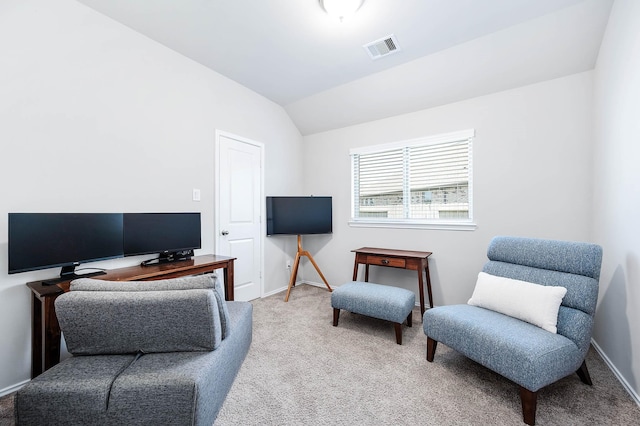 interior space featuring lofted ceiling, baseboards, visible vents, and carpet