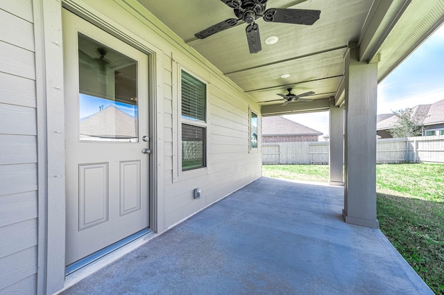 view of patio with fence and a ceiling fan