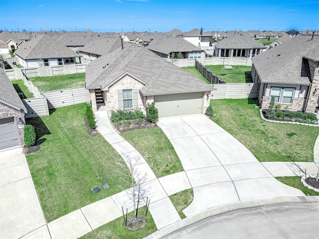 view of front of home featuring driveway, a shingled roof, a residential view, and a front lawn