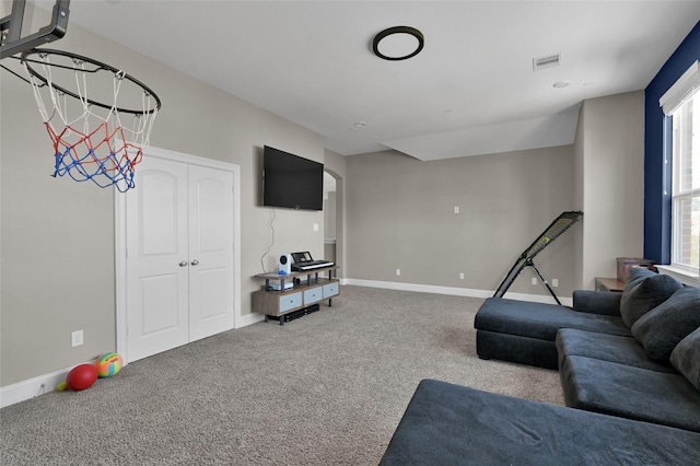 carpeted living room with visible vents and baseboards