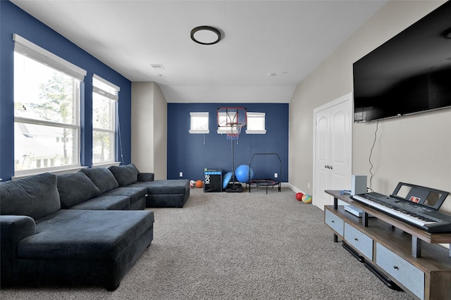 living room with carpet, visible vents, and baseboards