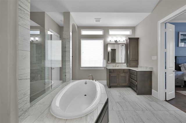 ensuite bathroom with ensuite bath, marble finish floor, vanity, a walk in shower, and a bath