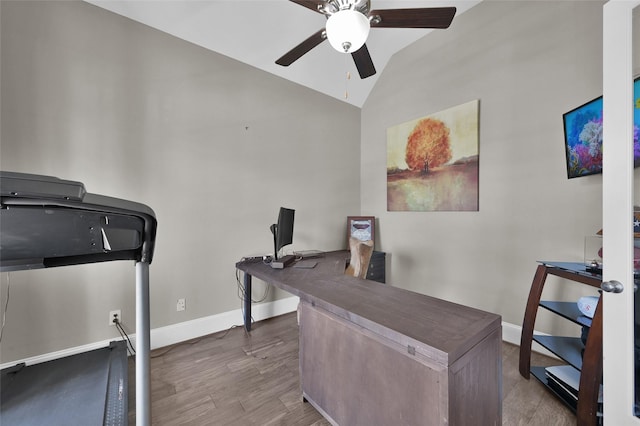 home office with vaulted ceiling, ceiling fan, wood finished floors, and baseboards