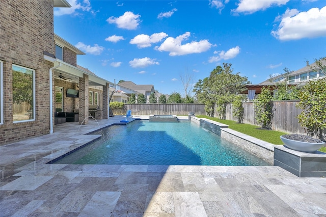 view of pool with a patio, a pool with connected hot tub, a fenced backyard, and a ceiling fan