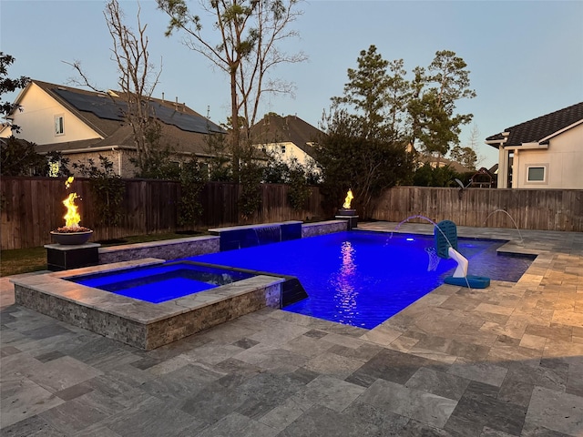 view of pool with a patio area, a fenced backyard, a fenced in pool, and an in ground hot tub