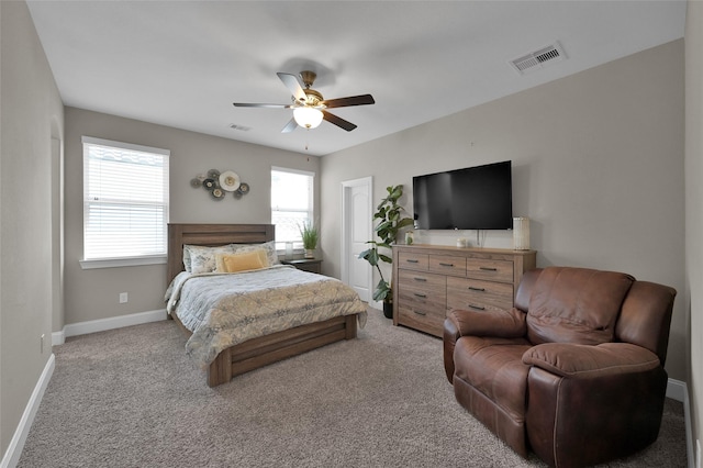 bedroom with carpet floors, visible vents, baseboards, and a ceiling fan