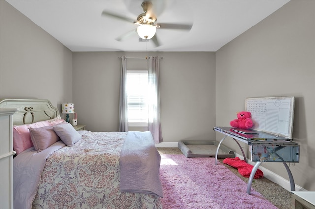 carpeted bedroom featuring a ceiling fan and baseboards