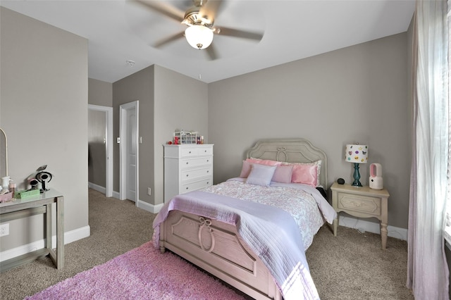 carpeted bedroom featuring a ceiling fan and baseboards