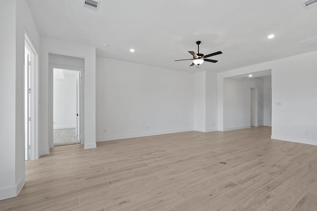 empty room featuring a ceiling fan, light wood-type flooring, visible vents, and recessed lighting