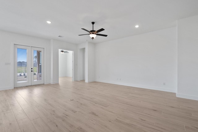 empty room with recessed lighting, light wood-style flooring, baseboards, and french doors