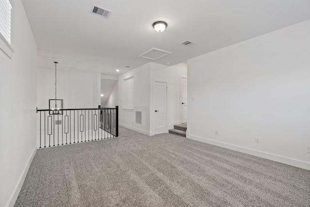 unfurnished room with carpet, baseboards, and visible vents