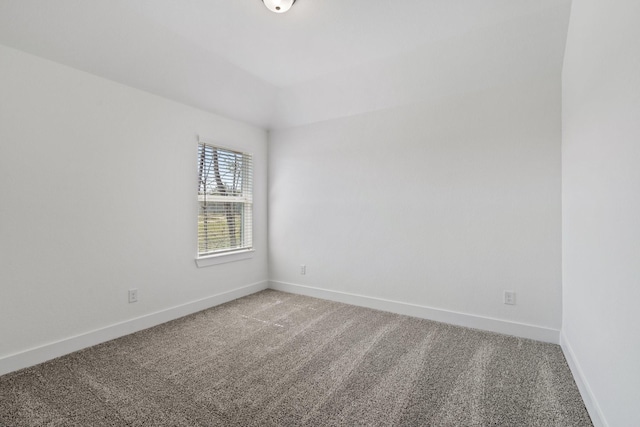 unfurnished room featuring light carpet and baseboards