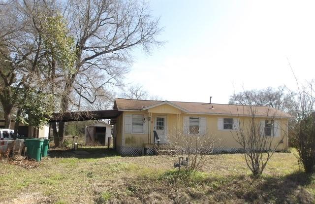 ranch-style home featuring a carport