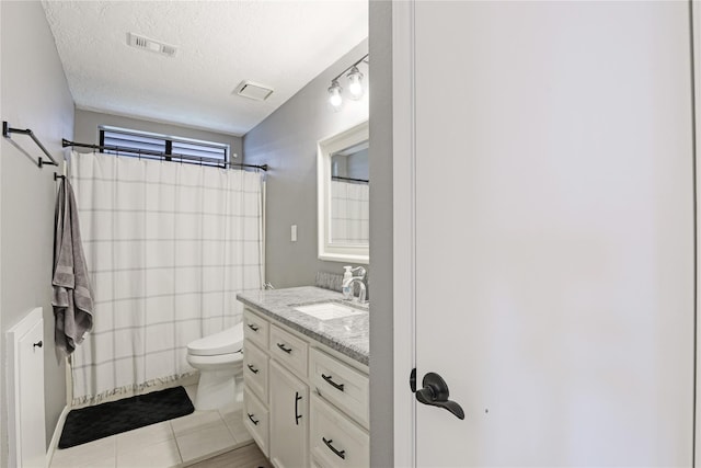 bathroom with visible vents, toilet, tile patterned floors, a textured ceiling, and vanity