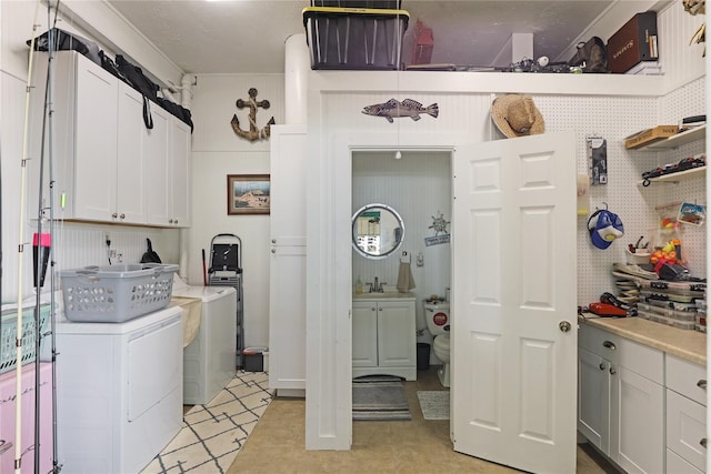 laundry area with a sink, cabinet space, and washer and dryer