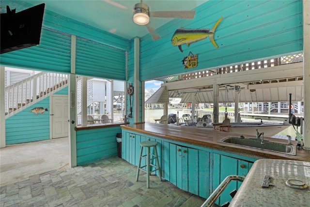 view of patio / terrace with stairway, a sink, and outdoor wet bar