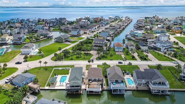 drone / aerial view with a water view and a residential view