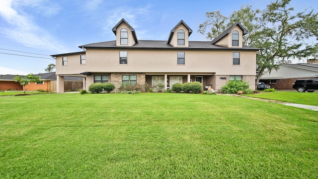 view of front of home featuring a front lawn, brick siding, and stucco siding