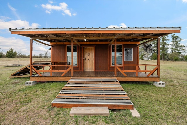 exterior space featuring metal roof and a front lawn