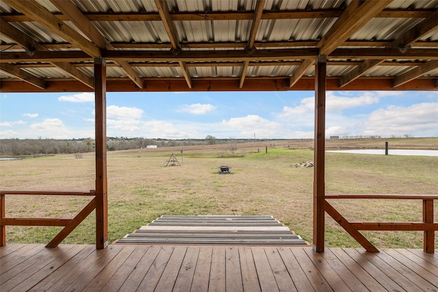 wooden deck with a yard and a rural view