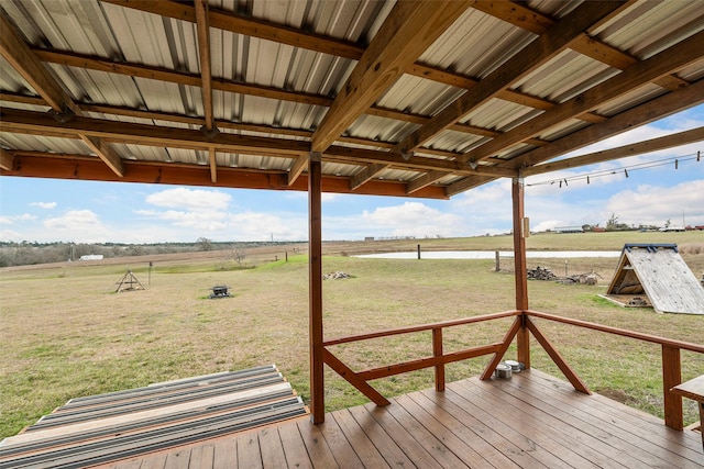 wooden deck featuring a rural view and a yard